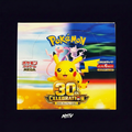 Pokemon 30th Celebration booster box on dark purple NMTV background